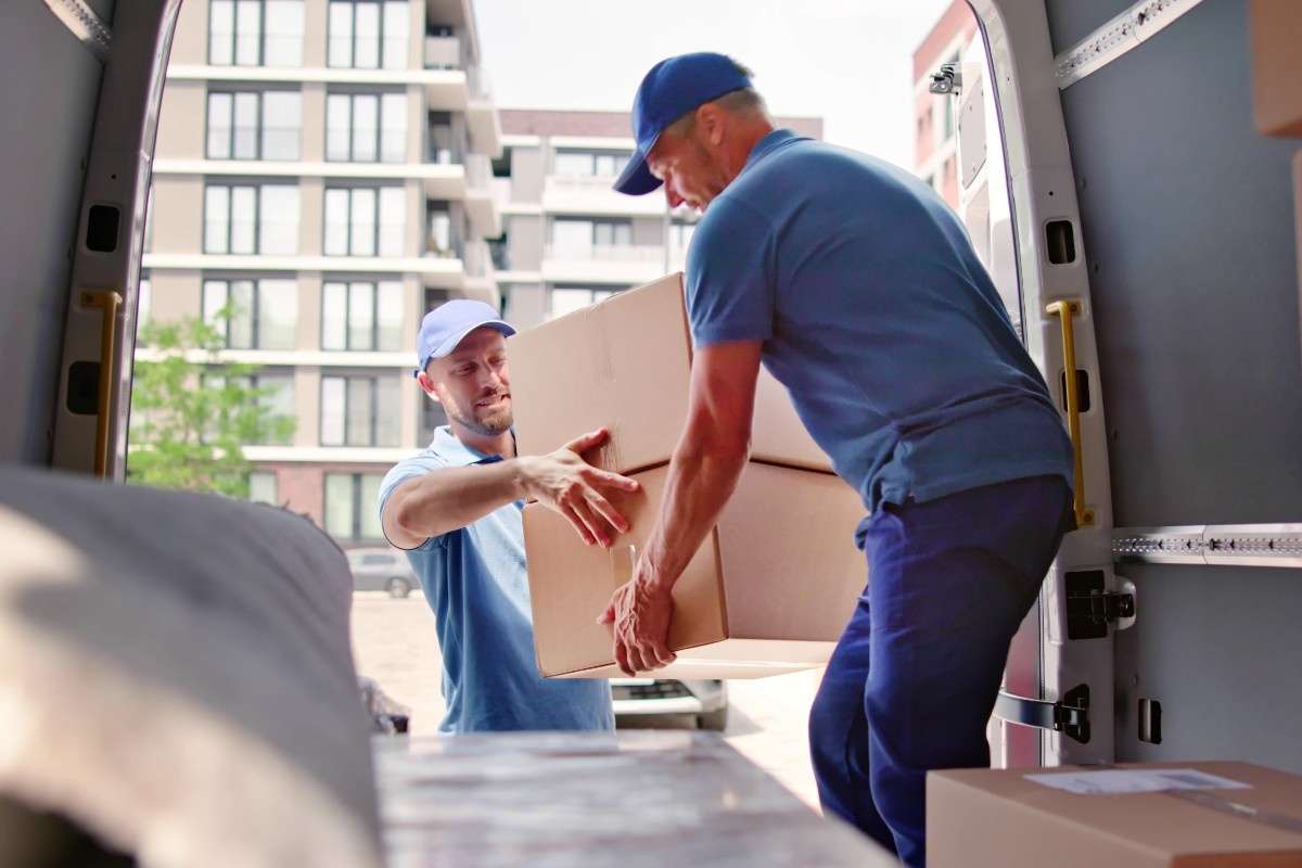 Two Tampa FL local movers loading boxes into the back of a van